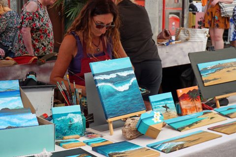 A craft fair booth display featuring five profitable product categories including tumblers, keychains, tote bags, beadable pens, and resin home decor.