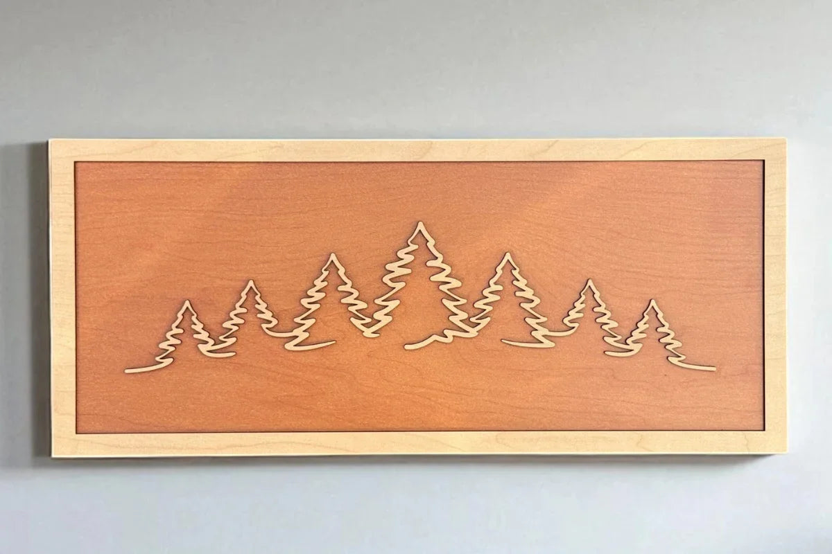TruFlat plywood sheets in maple, walnut, cherry, and oak shown alongside laser-engraved finished pieces.
