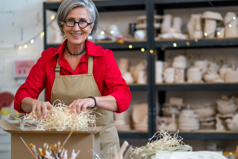 A woman packaging an order at her studio.