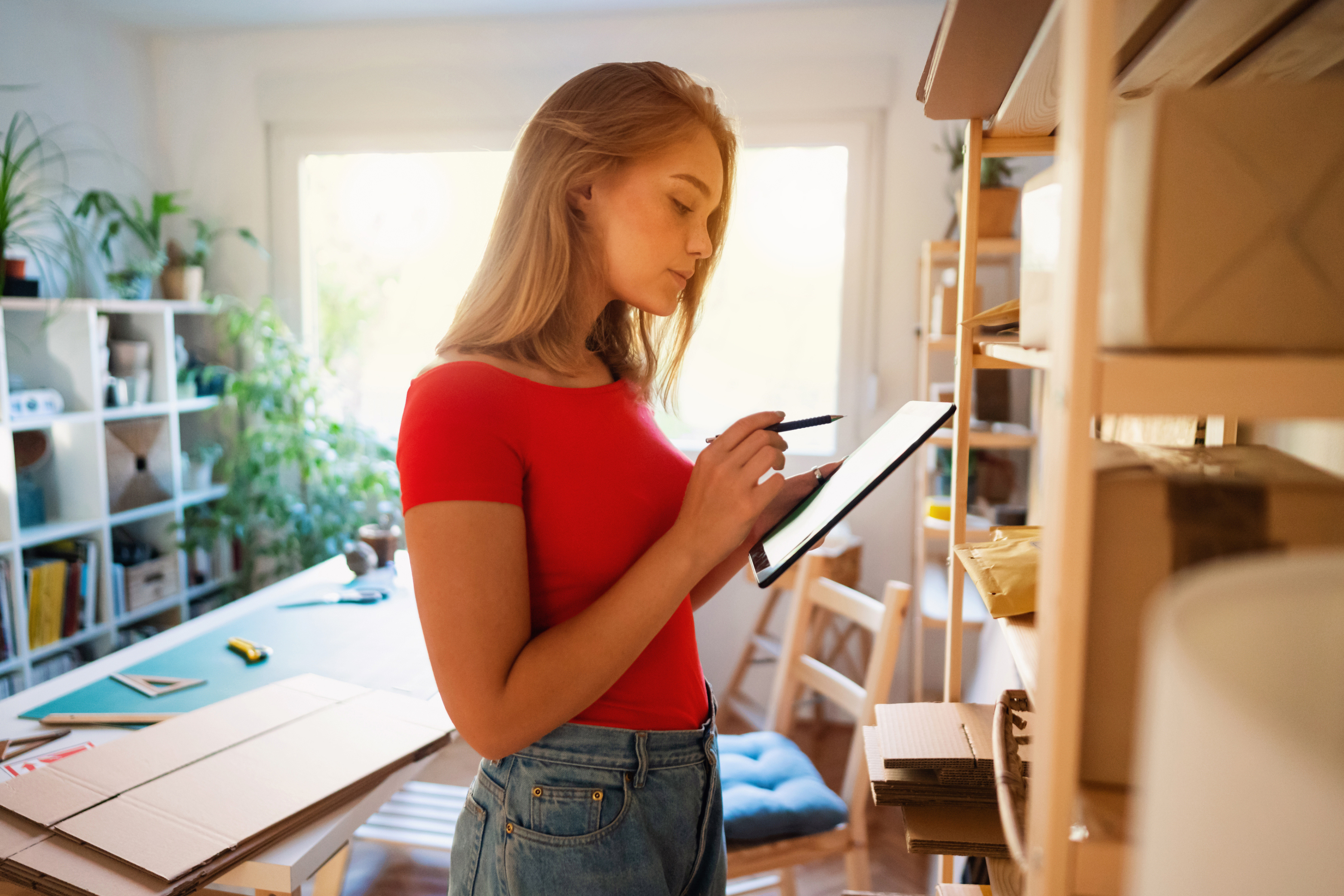 A girl looking at her tablet in a studio.