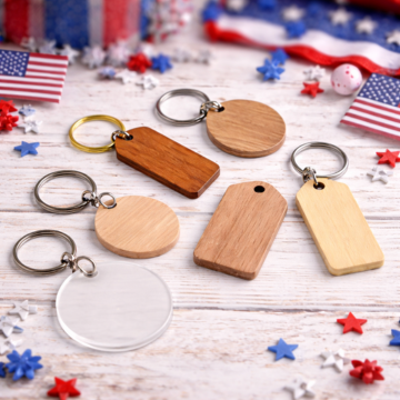 Blank wood and acrylic keychains for crafts on rustic table with patriotic USA decorations