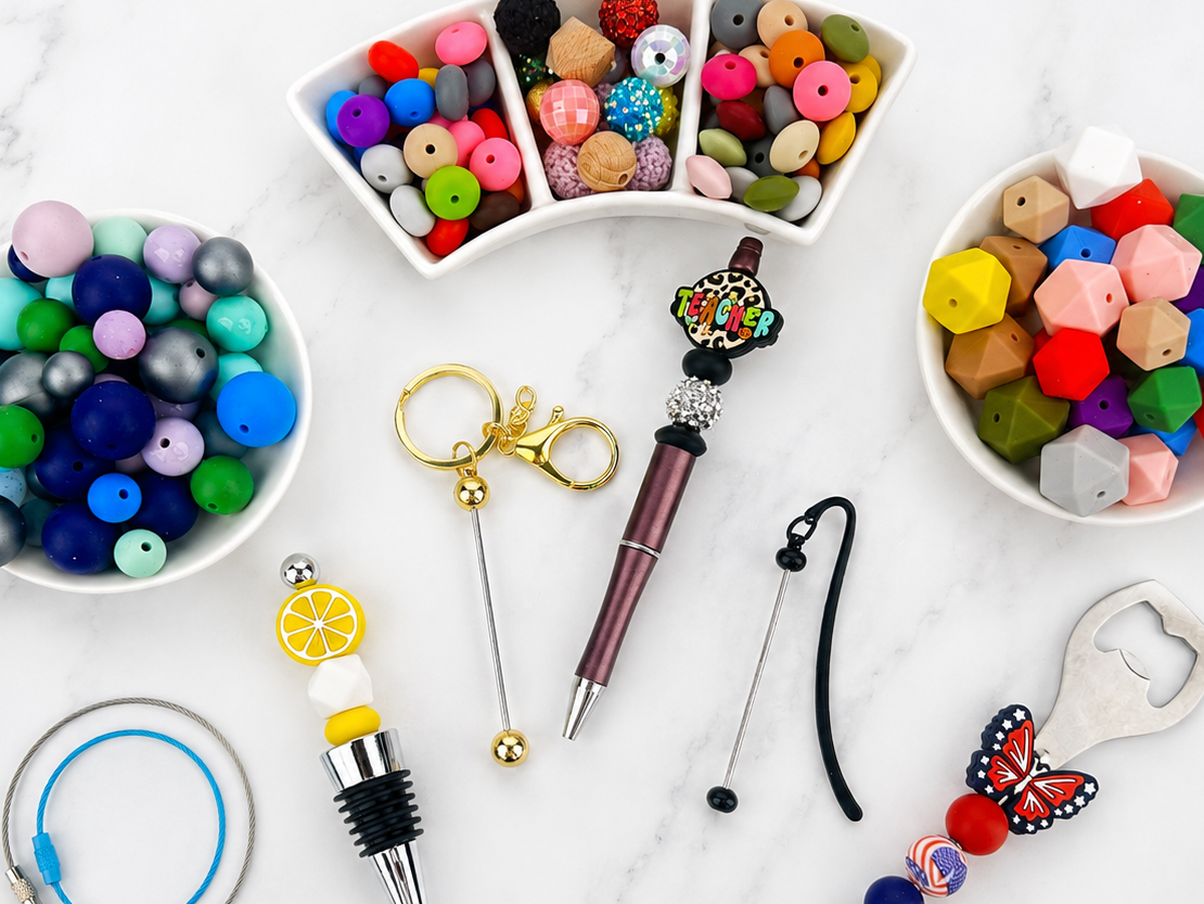 Colorful beaded keychains, bottle openers, and other accessories on a white surface.