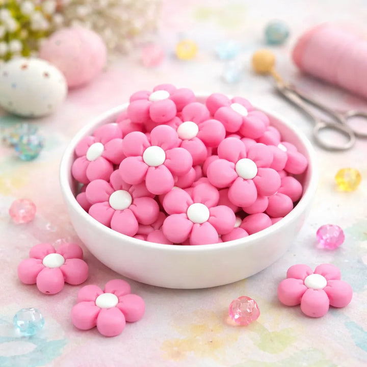 Pink flower-shaped candies in a white bowl on a colorful background