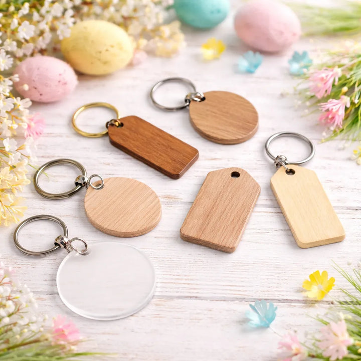 Wooden keychains on a light wooden surface with Easter eggs and flowers.