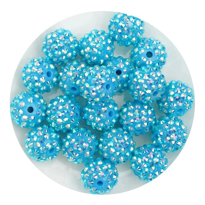 Round blue acrylic bling beads with rhinestone accents for DIY jewelry and crafts.